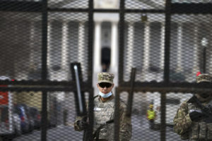 Members of the National Guard stand inside the security fencing at the Capitol ahead of the inauguration of President-elect Joe Biden and Vice President-elect Kamala Harris, Sunday, Jan. 17, 2021 in Washington. (AP Photo/John Minchillo)